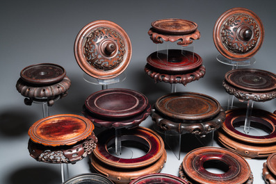 20 Chinese wooden stands and two reticulated covers, 19/20th C.