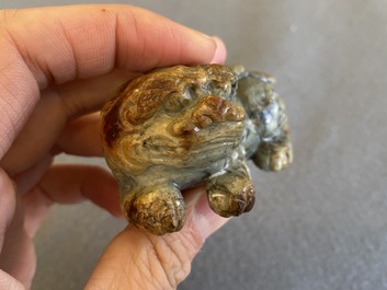 Two Chinese celadon and russet jade Buddhist lion sculptures, Qing