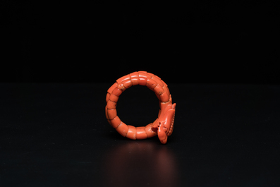 A Chinese red coral bracelet with a dragon's or snake's head, 19th C.