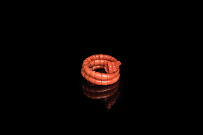 A Chinese red coral bracelet with a dragon's or snake's head, 19th C.