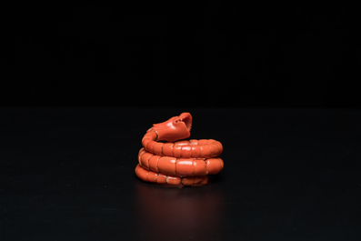 A Chinese red coral bracelet with a dragon's or snake's head, 19th C.
