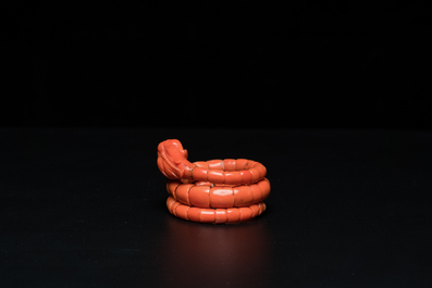 A Chinese red coral bracelet with a dragon's or snake's head, 19th C.