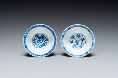 A pair of Chinese blue and white reticulated double-walled cups and saucers, Kangxi