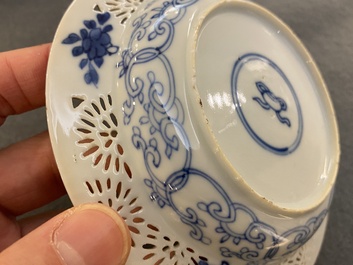 A pair of Chinese blue and white reticulated double-walled cups and saucers, Kangxi