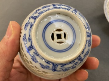 A pair of Chinese blue and white reticulated double-walled cups and saucers, Kangxi