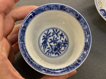 A pair of Chinese blue and white reticulated double-walled cups and saucers, Kangxi