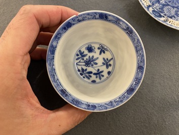 A pair of Chinese blue and white reticulated double-walled cups and saucers, Kangxi