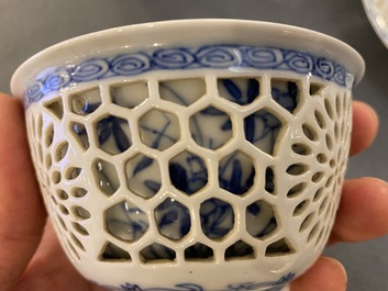 A pair of Chinese blue and white reticulated double-walled cups and saucers, Kangxi