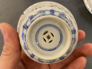 A pair of Chinese blue and white reticulated double-walled cups and saucers, Kangxi