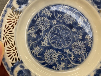 A pair of Chinese blue and white reticulated double-walled cups and saucers, Kangxi
