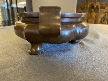 A Chinese lotus-shaped bronze tripod censer, late Ming or early Qing