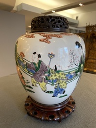 A Chinese famille verte jar with wooden cover and stand, 19th C.