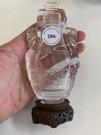 A Chinese rock crystal covered vase on wooden stand, 19/20th C.