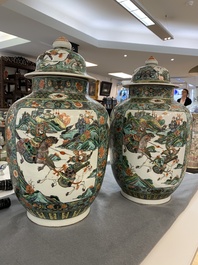 A pair of  Chinese famille verte vases and covers, 19th C.