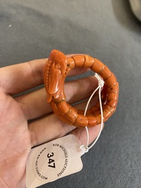 A Chinese red coral bracelet with a dragon's or snake's head, 19th C.