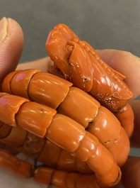 A Chinese red coral bracelet with a dragon's or snake's head, 19th C.