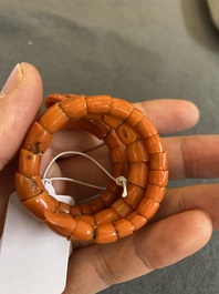 A Chinese red coral bracelet with a dragon's or snake's head, 19th C.
