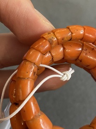 A Chinese red coral bracelet with a dragon's or snake's head, 19th C.