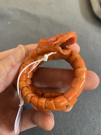 A Chinese red coral bracelet with a dragon's or snake's head, 19th C.