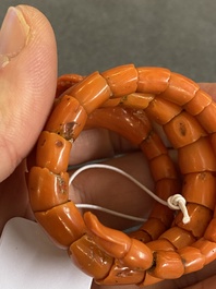 A Chinese red coral bracelet with a dragon's or snake's head, 19th C.