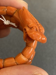 A Chinese red coral bracelet with a dragon's or snake's head, 19th C.