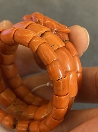 A Chinese red coral bracelet with a dragon's or snake's head, 19th C.