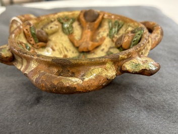 A slip-decorated three-handled earthenware bowl, probably Germany, 16/17th C.