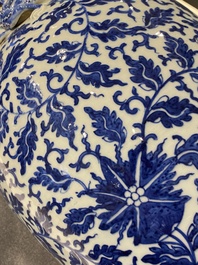 A pair of Chinese blue and white covered vases with floral sprigs, 19th C.