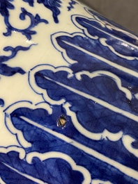 A pair of Chinese blue and white covered vases with floral sprigs, 19th C.