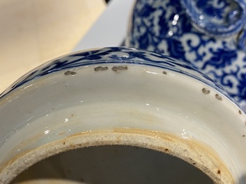 A pair of Chinese blue and white covered vases with floral sprigs, 19th C.