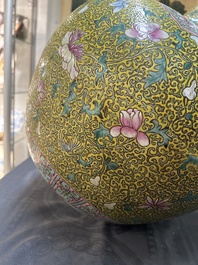 A large Chinese famille rose yellow-ground bottle vase, Qianlong mark, 19th C.