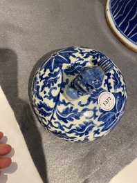 A pair of Chinese blue and white covered vases with floral sprigs, 19th C.