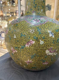 A large Chinese famille rose yellow-ground bottle vase, Qianlong mark, 19th C.