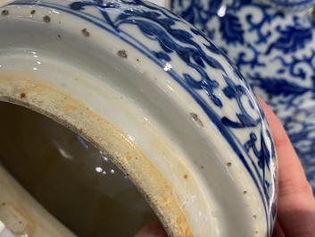 A pair of Chinese blue and white covered vases with floral sprigs, 19th C.