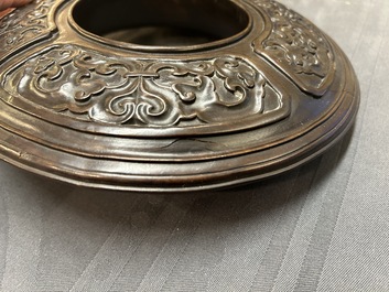 A Chinese relief-decorated alms bowl with wooden lid, Qianlong mark, 19/20th C.