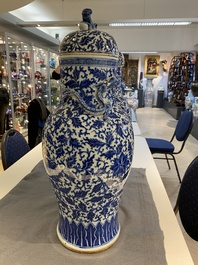 A pair of Chinese blue and white covered vases with floral sprigs, 19th C.