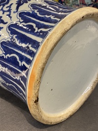 A pair of Chinese blue and white covered vases with floral sprigs, 19th C.