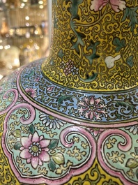 A large Chinese famille rose yellow-ground bottle vase, Qianlong mark, 19th C.