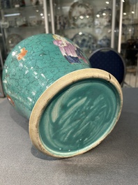 A Chinese turquoise-ground famille rose 'boys at a pomegranate tree' vase and cover, 19th C.