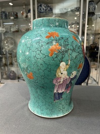 A Chinese turquoise-ground famille rose 'boys at a pomegranate tree' vase and cover, 19th C.