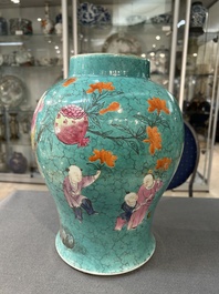 A Chinese turquoise-ground famille rose 'boys at a pomegranate tree' vase and cover, 19th C.