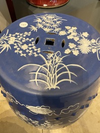 A pair of Chinese white slip-decorated blue-ground garden seats, 19th C.