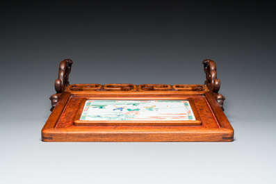 A Chinese famille verte plaque set in a partly huanghuali wooden table screen, Kangxi