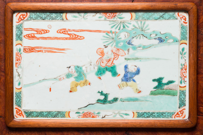 A Chinese famille verte plaque set in a partly huanghuali wooden table screen, Kangxi