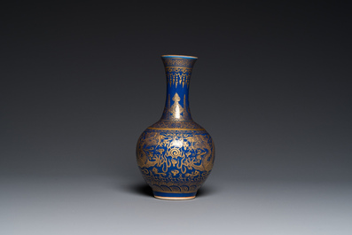 A Chinese monochrome blue gilt-decorated 'dragons' bottle vase, Qianlong mark, 19th C.
