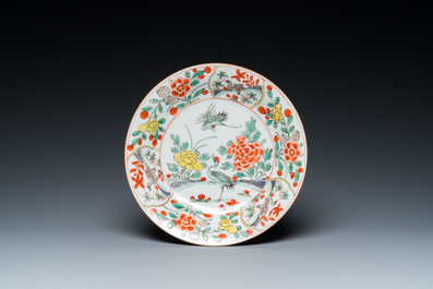 A Chinese famille verte 'cranes' plate and a 'peony scroll' bowl, Kangxi