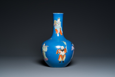 A Chinese blue-ground famille rose 'eight immortals' bottle vase, Qianlong mark, 19th C.