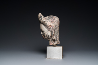 A Khmer stone head with traces of polychromy, Cambodia or Thailand, 13/16th C.