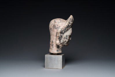A Khmer stone head with traces of polychromy, Cambodia or Thailand, 13/16th C.