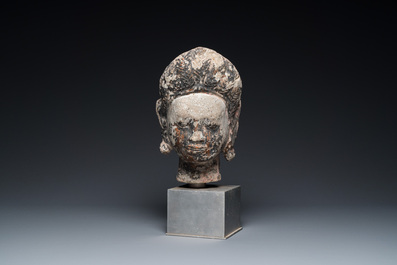 A Khmer stone head with traces of polychromy, Cambodia or Thailand, 13/16th C.